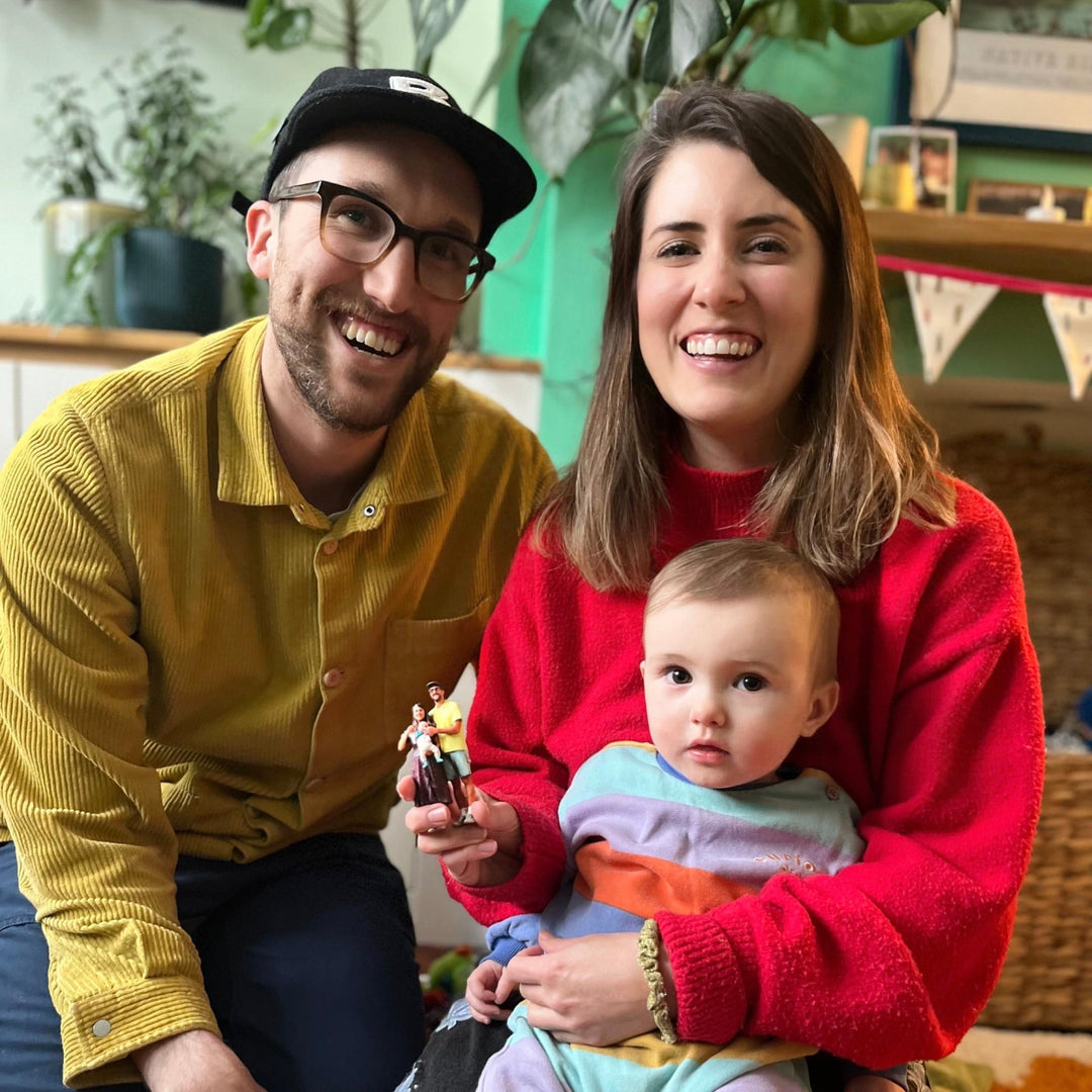 Family posing with 3d printed family figurine